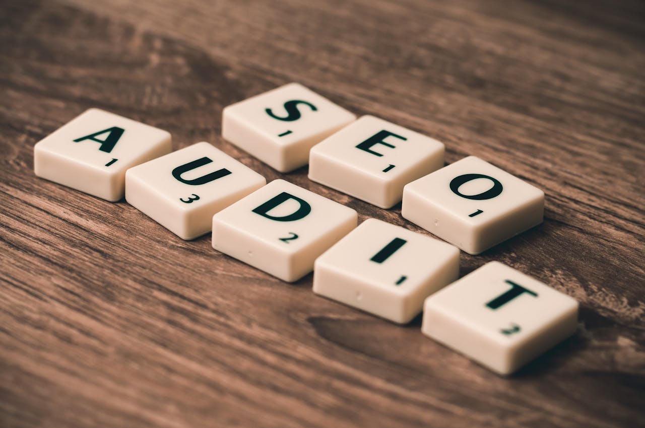 home-hero Scrabble tiles spelling SEO Audit on wooden surface, symbolizing digital marketing strategies.